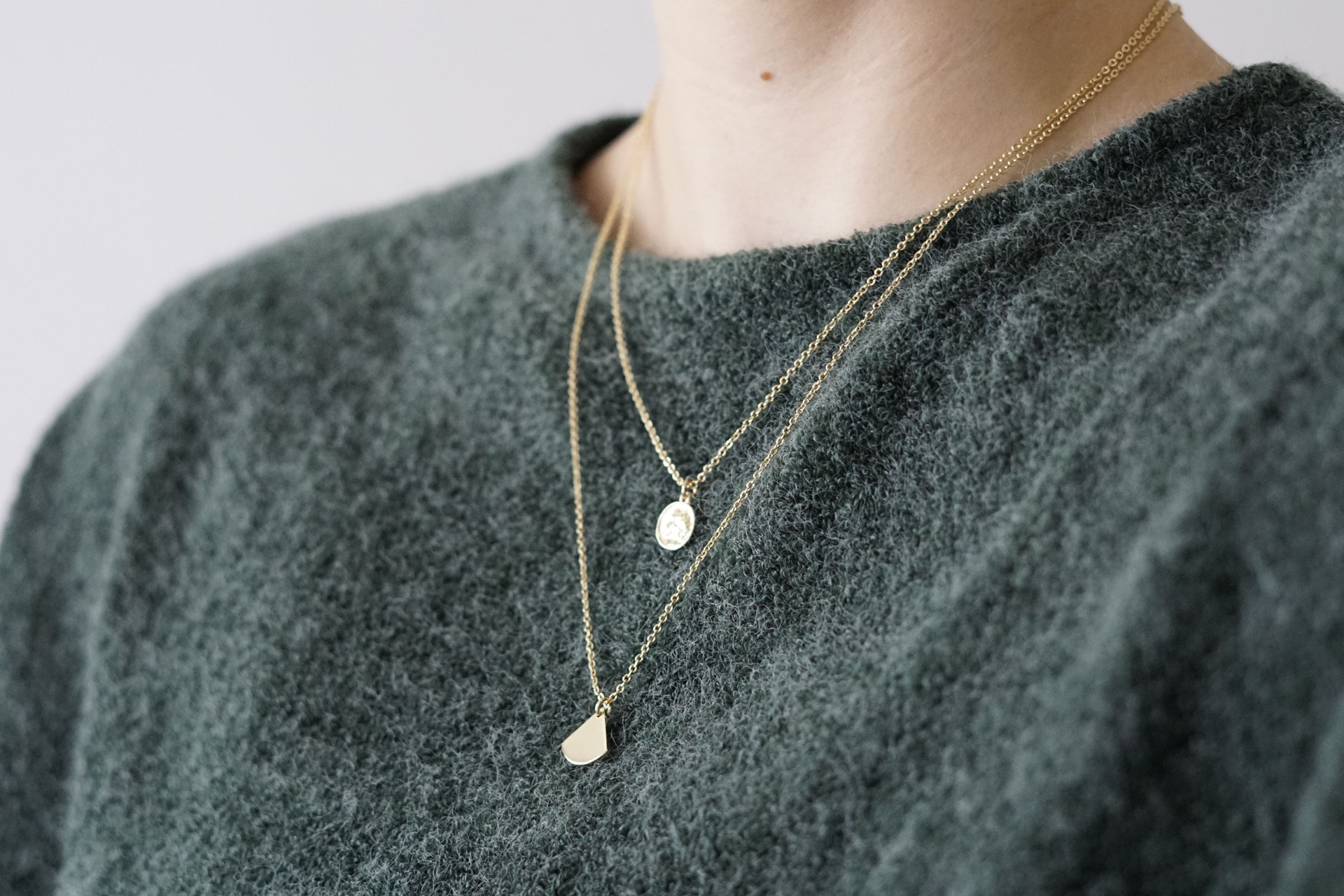 Female wearing a luxury layered necklace, closeup